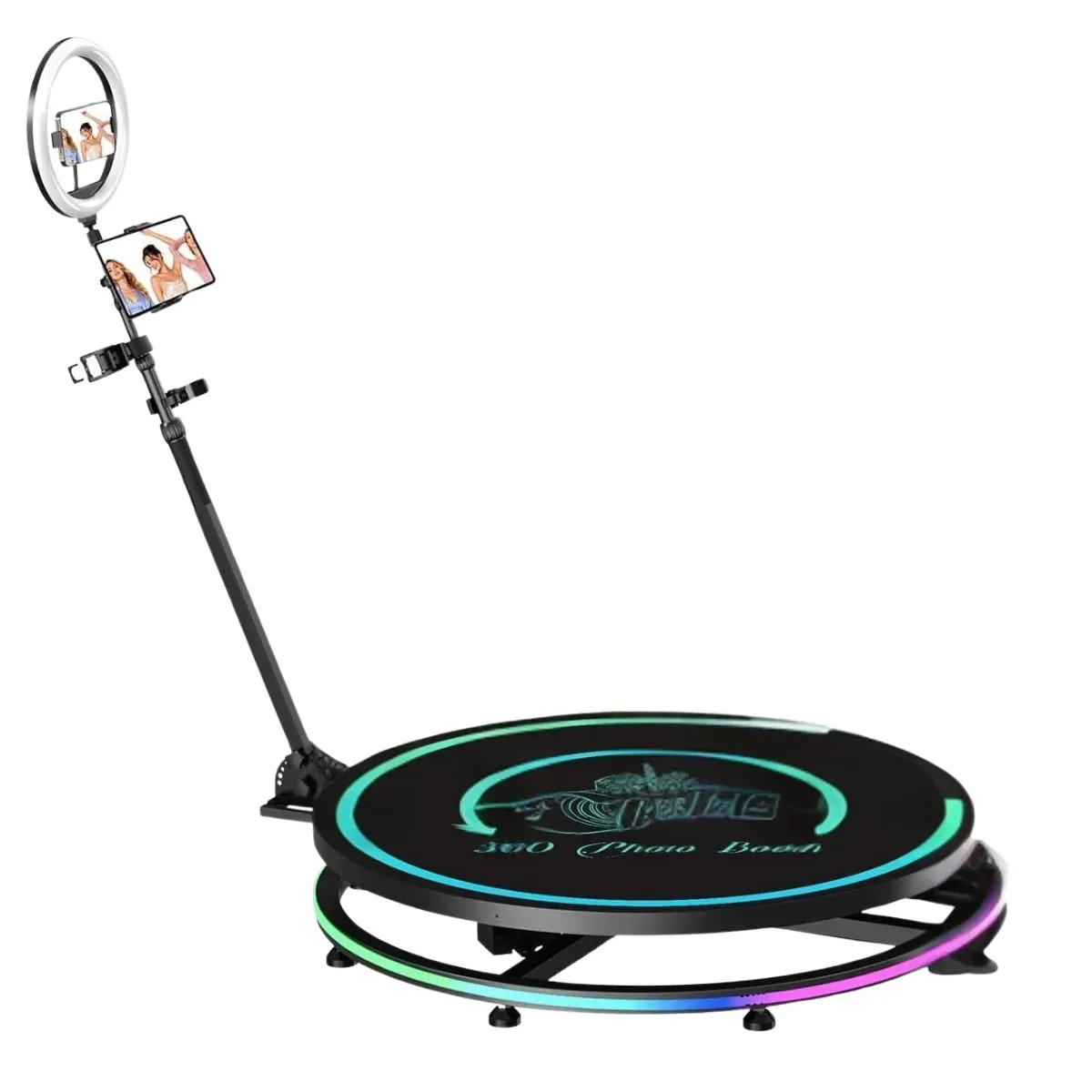 A round black 360 photo booth platform with a colour-shifting light strip around its rim, standing on short feet, with a tall arm rising from one side carrying a ring light and a phone and tablet mount at the top