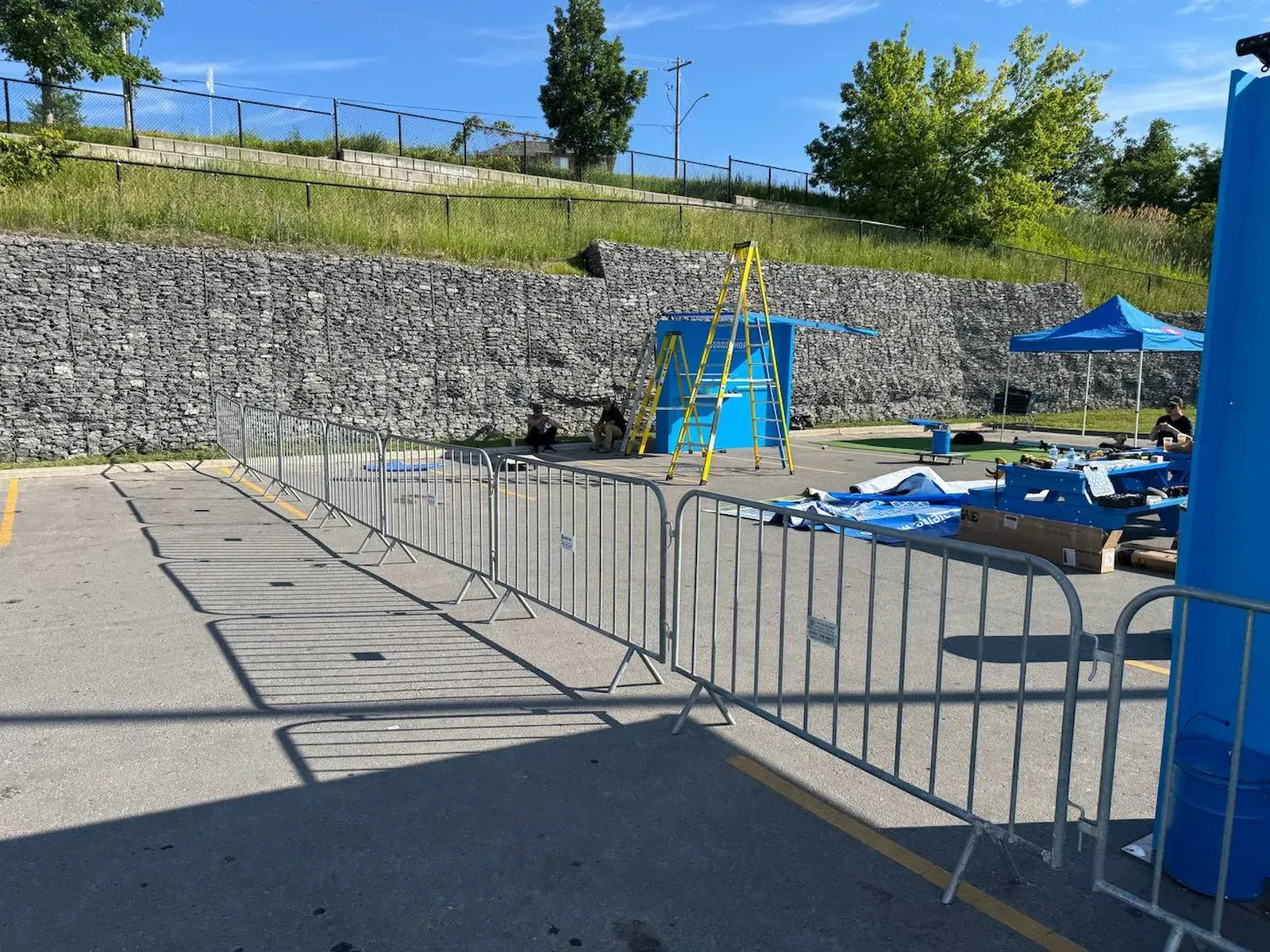 Steel sections hooked end to end into a continuous perimeter around the working side of an event site